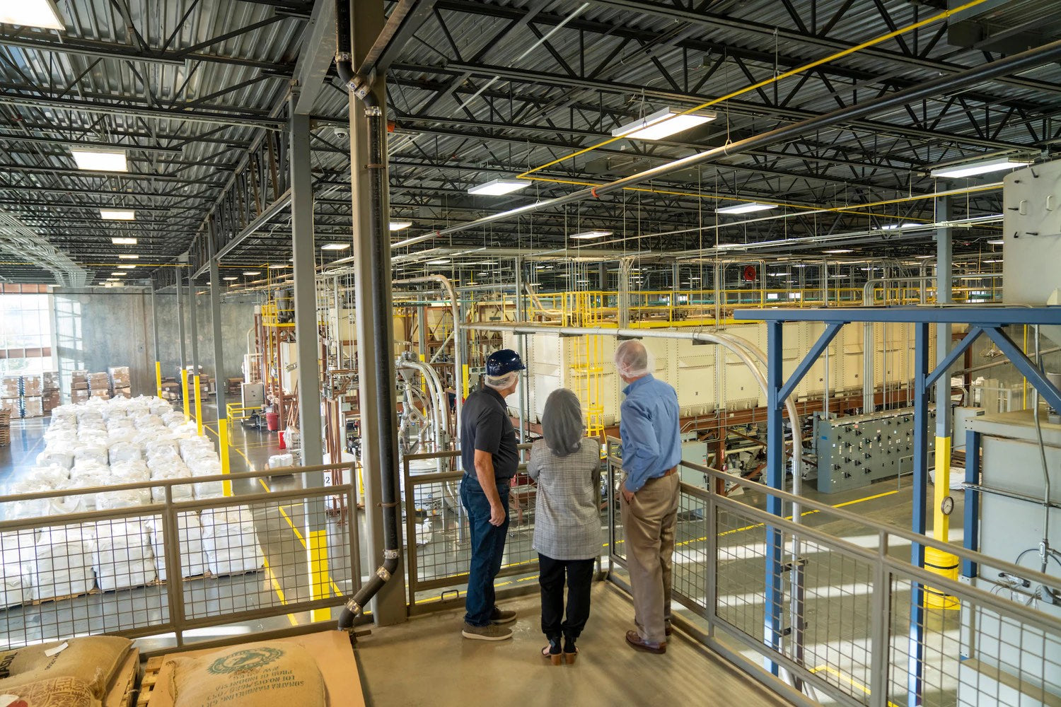 employees viewing manufacturing plant