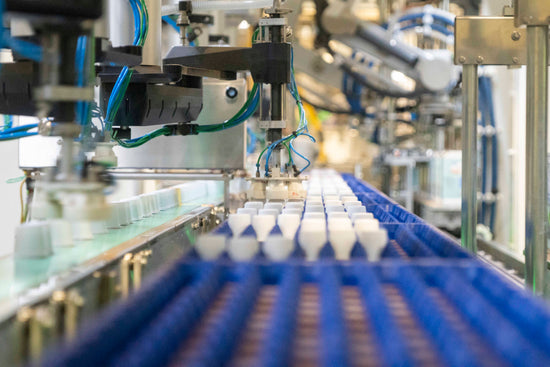 production line robots sorting single serve coffee